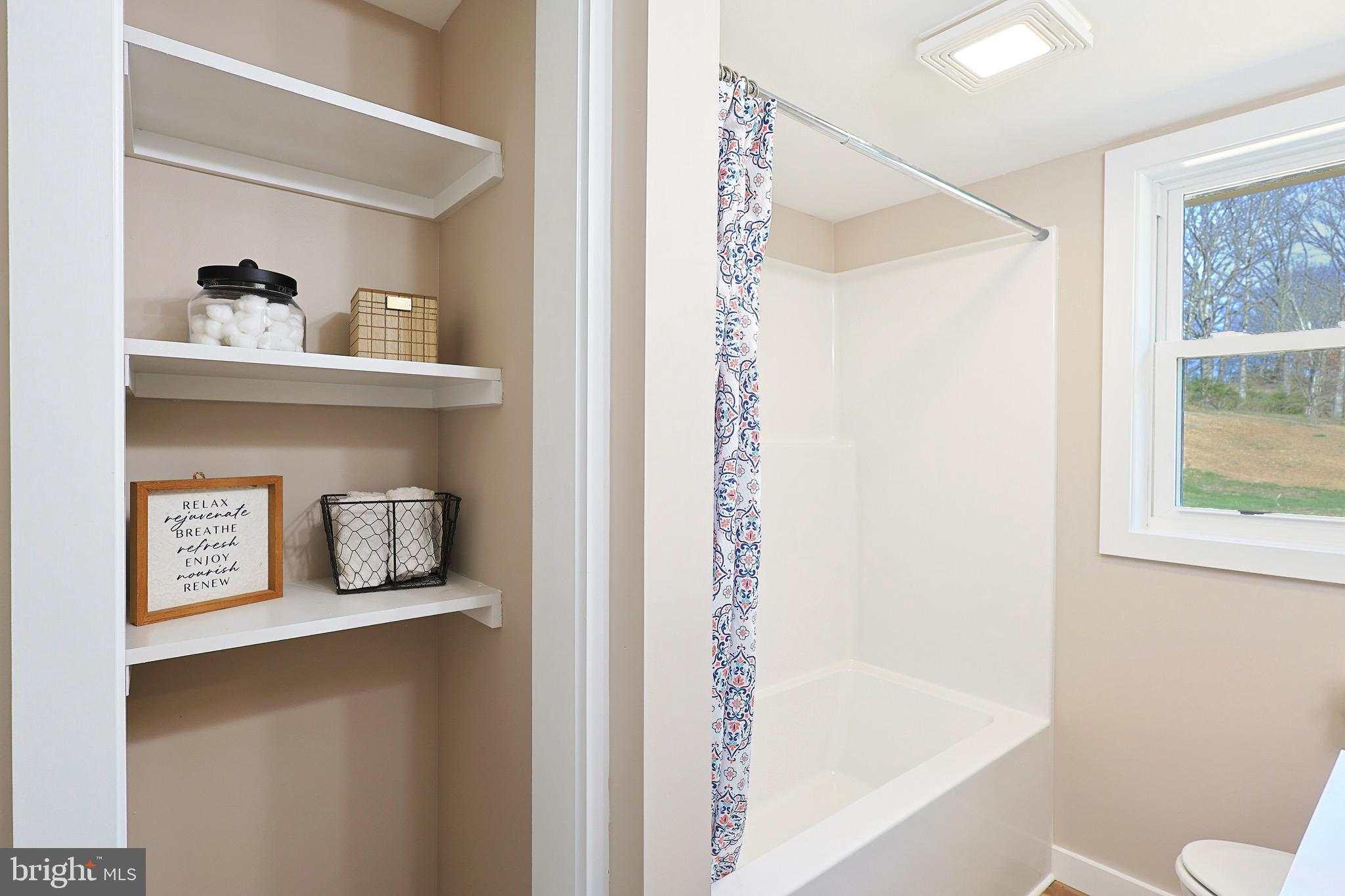 502 Sol Shanholtz Road Augusta, WV 26704 - Photo 26 of 61 a bathroom with a bathtub and a shower