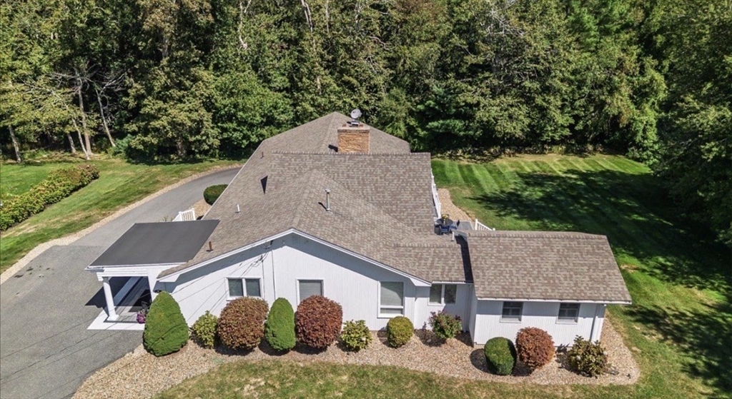 an aerial view of a house with a yard