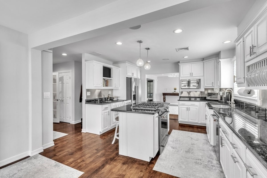 6 Strathmore Road Dartmouth, MA 02747 - Photo 13 of 38 a kitchen with white cabinets and stainless steel appliances