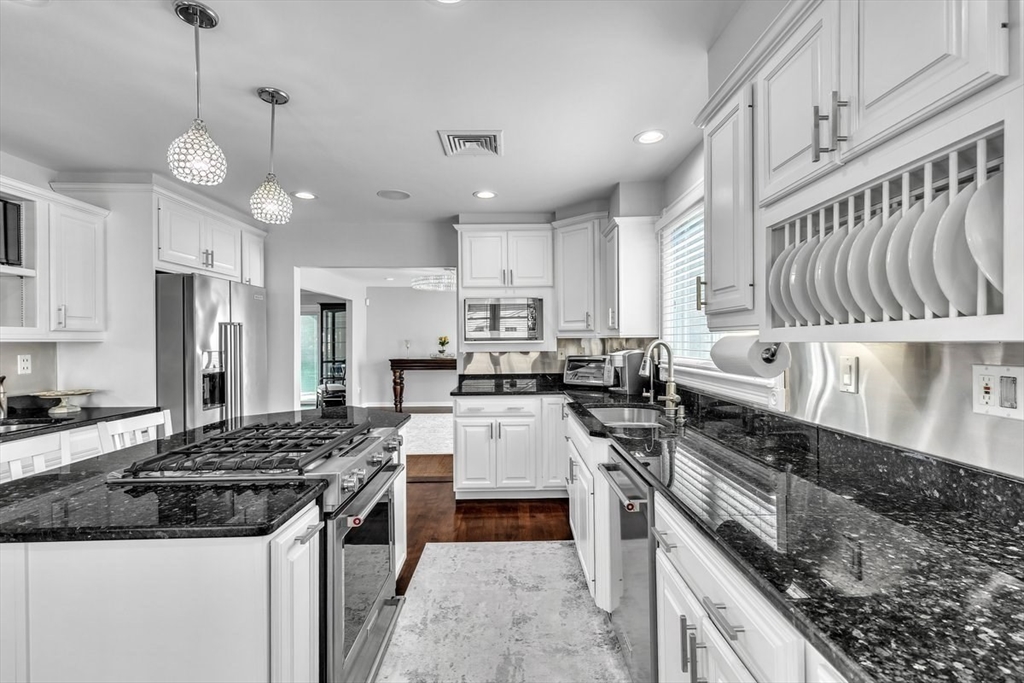 6 Strathmore Road Dartmouth, MA 02747 - Photo 14 of 38 a kitchen with a stove oven and white cabinets