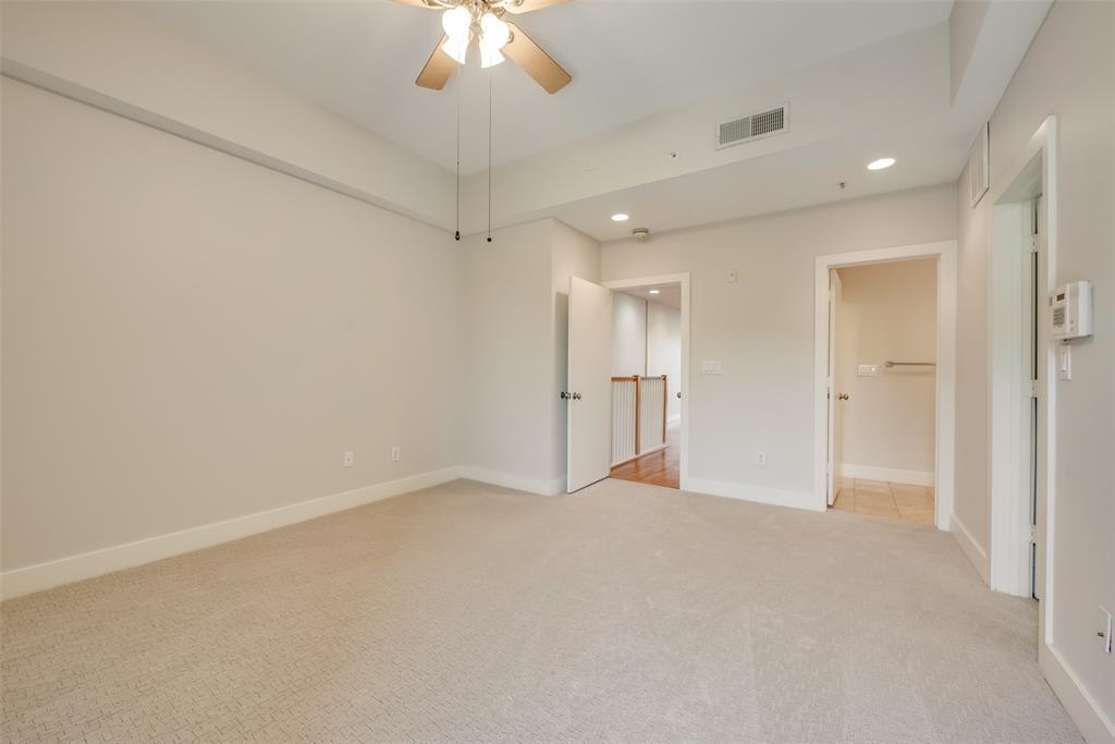 5055 Addison Circle, Unit 407 Addison, TX 75001 - Photo 16 of 22 Primary Bedroom with Ensuite Bath and Small Balcony (with Spacious Closet) on Upper Level
