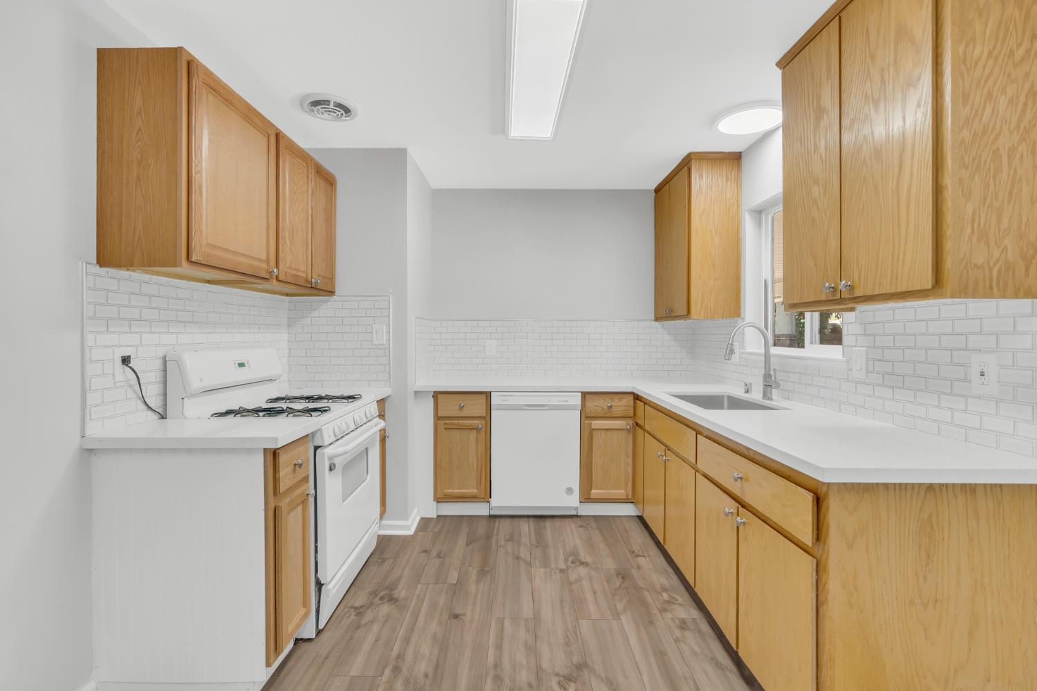 5720 Riverside Boulevard Sacramento, CA 95822 - Photo 30 of 54 a kitchen with a sink stove top oven and cabinets