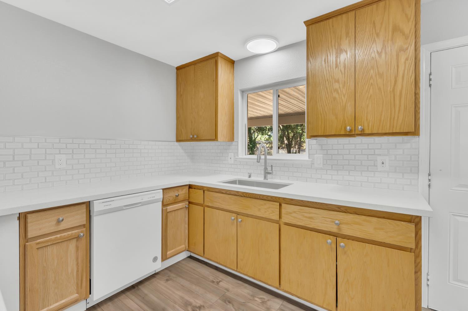 5720 Riverside Boulevard Sacramento, CA 95822 - Photo 32 of 54 a kitchen with a sink cabinets and wooden floor