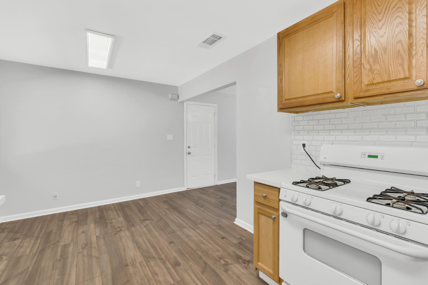 5720 Riverside Boulevard Sacramento, CA 95822 - Photo 33 of 54 a white kitchen with a stove and a sink