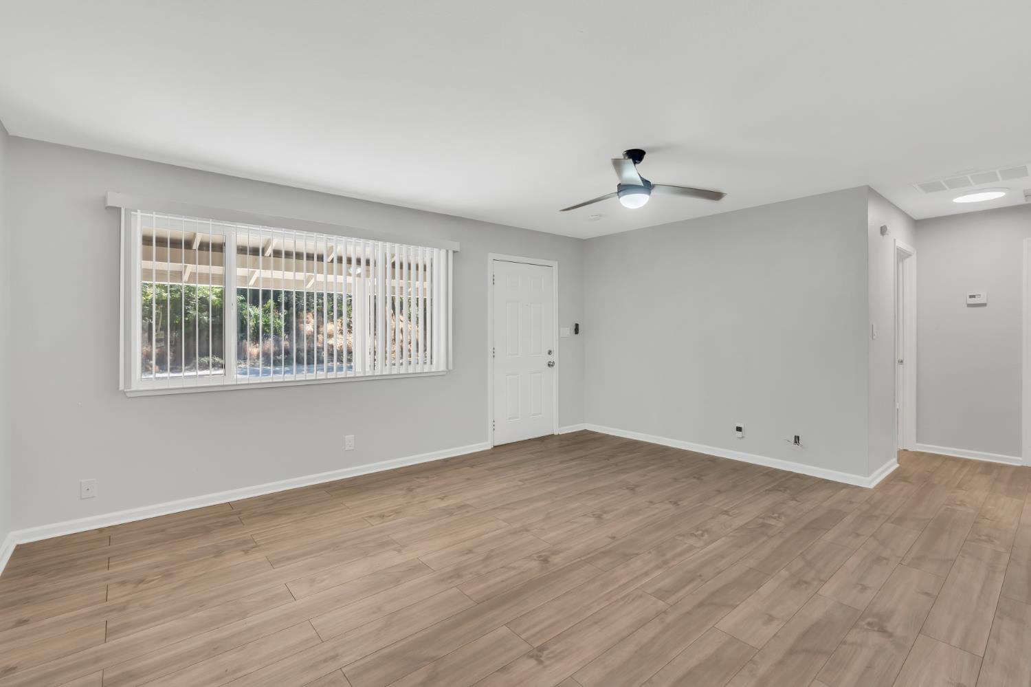 5720 Riverside Boulevard Sacramento, CA 95822 - Photo 40 of 54 wooden floor in an empty room with a window