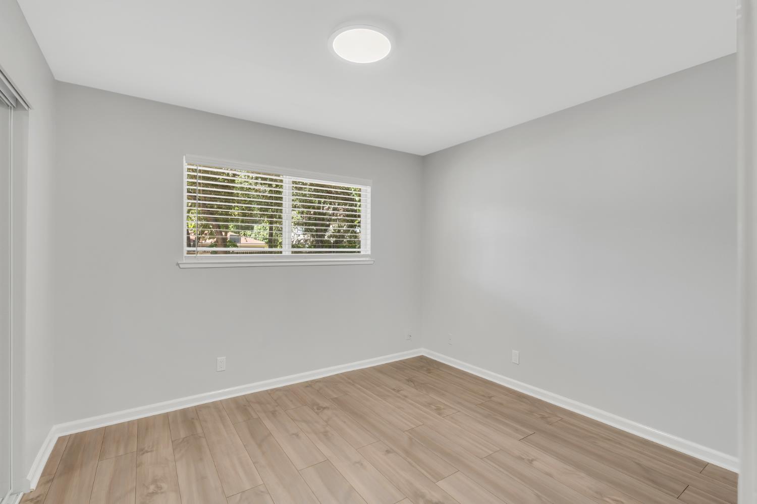 5720 Riverside Boulevard Sacramento, CA 95822 - Photo 42 of 54 wooden floor in an empty room with a window