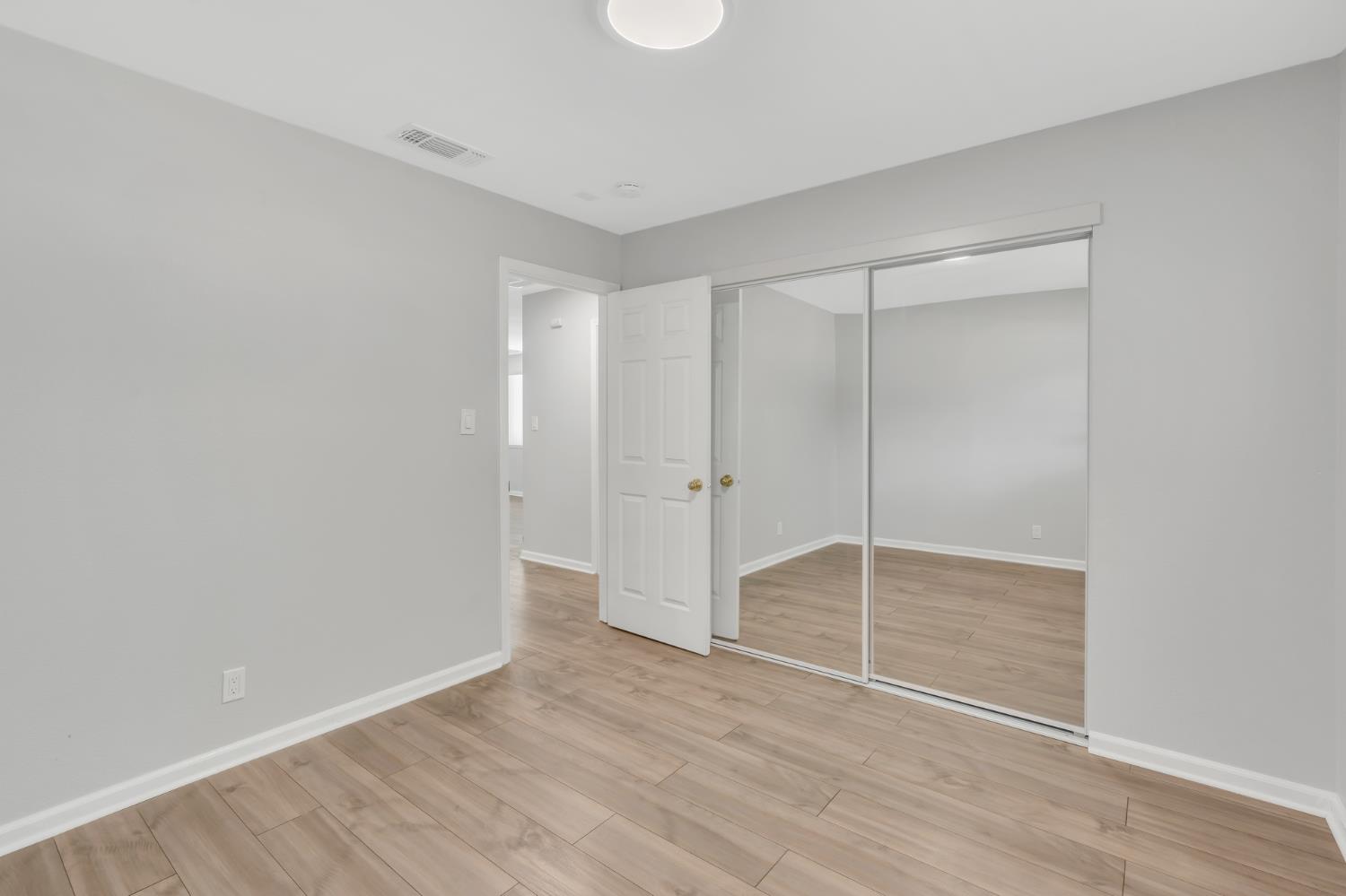 5720 Riverside Boulevard Sacramento, CA 95822 - Photo 43 of 54 a view of an empty room with wooden floor