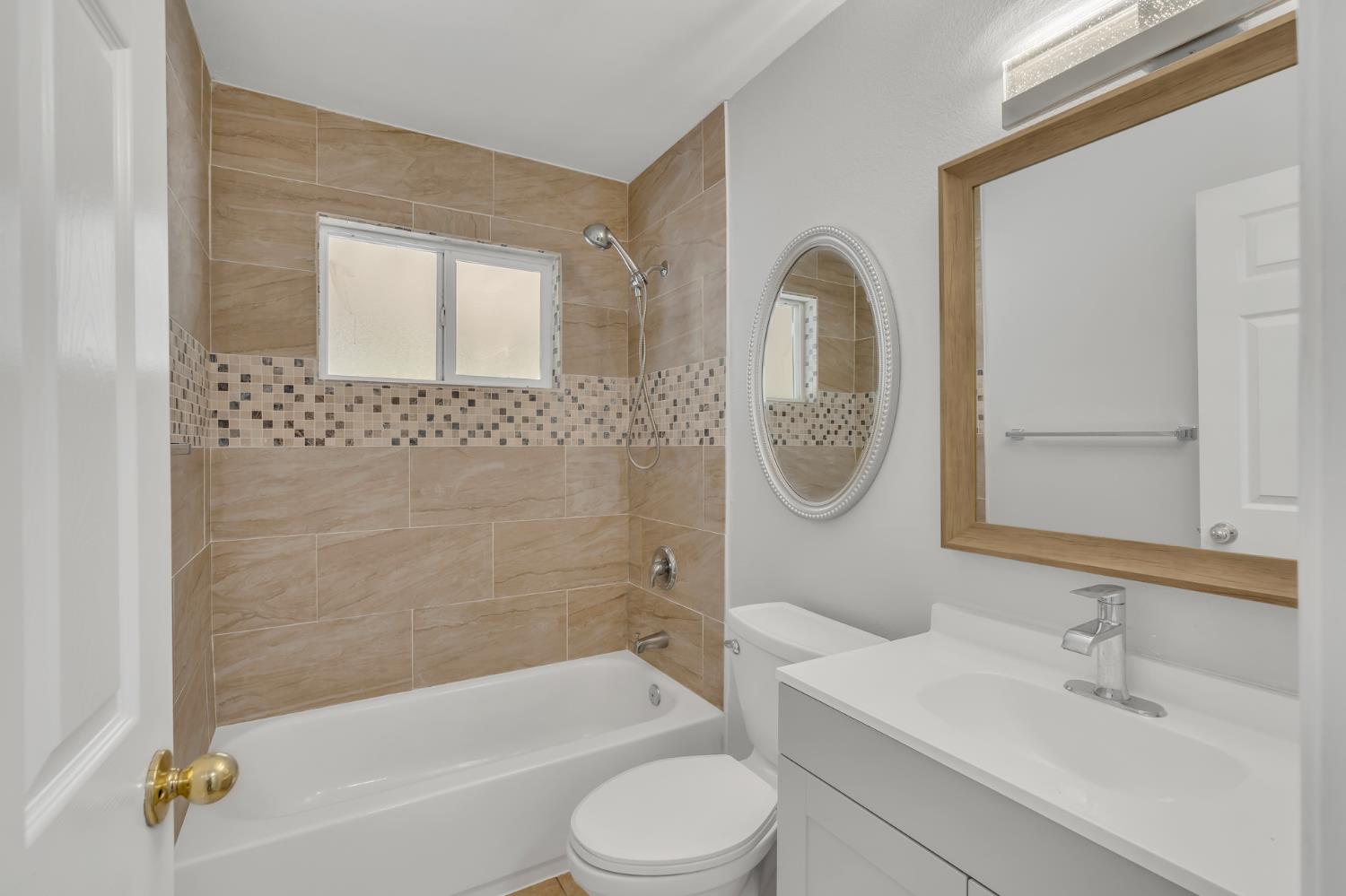 5720 Riverside Boulevard Sacramento, CA 95822 - Photo 44 of 54 a bathroom with a toilet a sink and bathtub