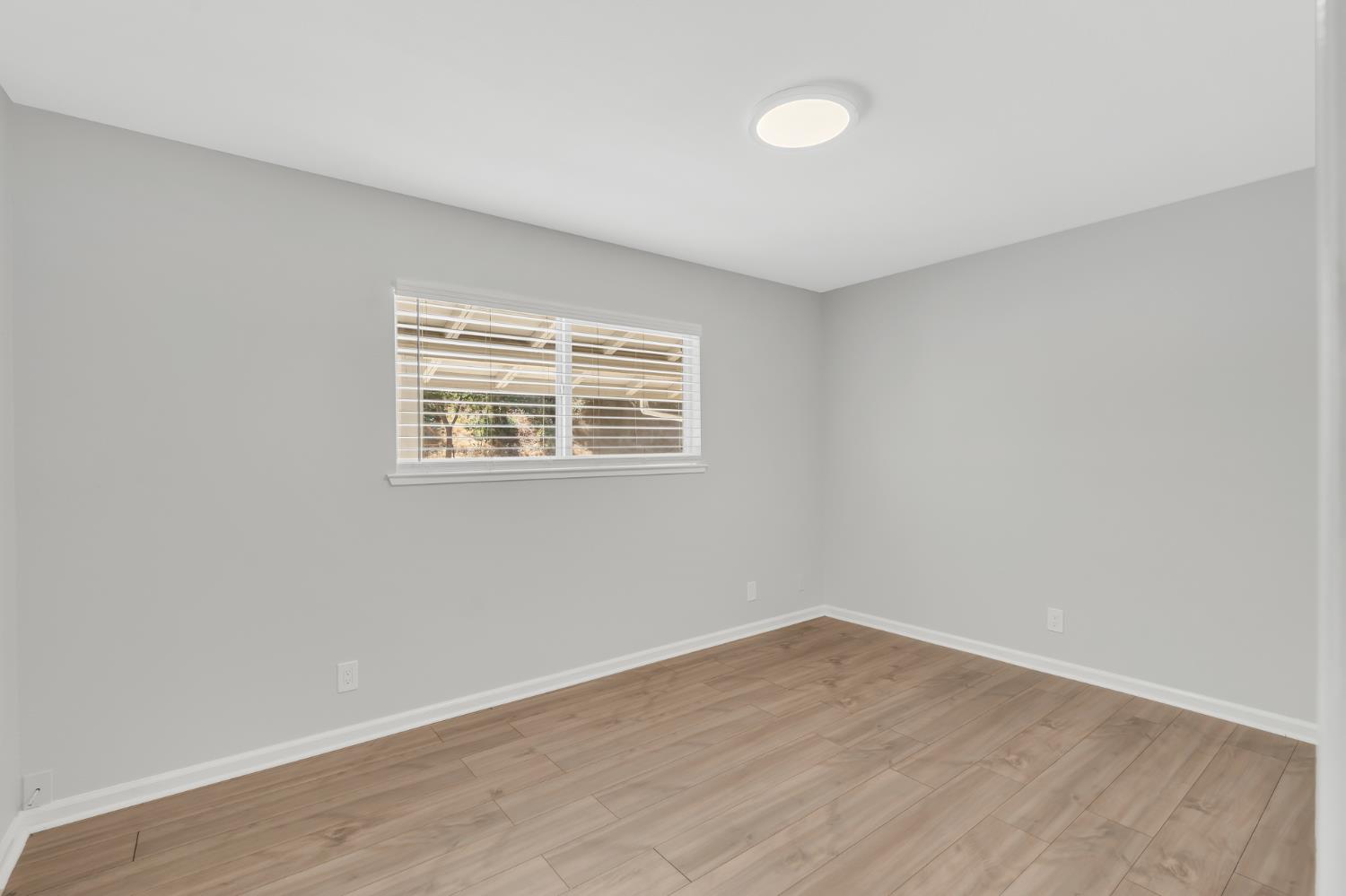 5720 Riverside Boulevard Sacramento, CA 95822 - Photo 46 of 54 wooden floor in an empty room with a window