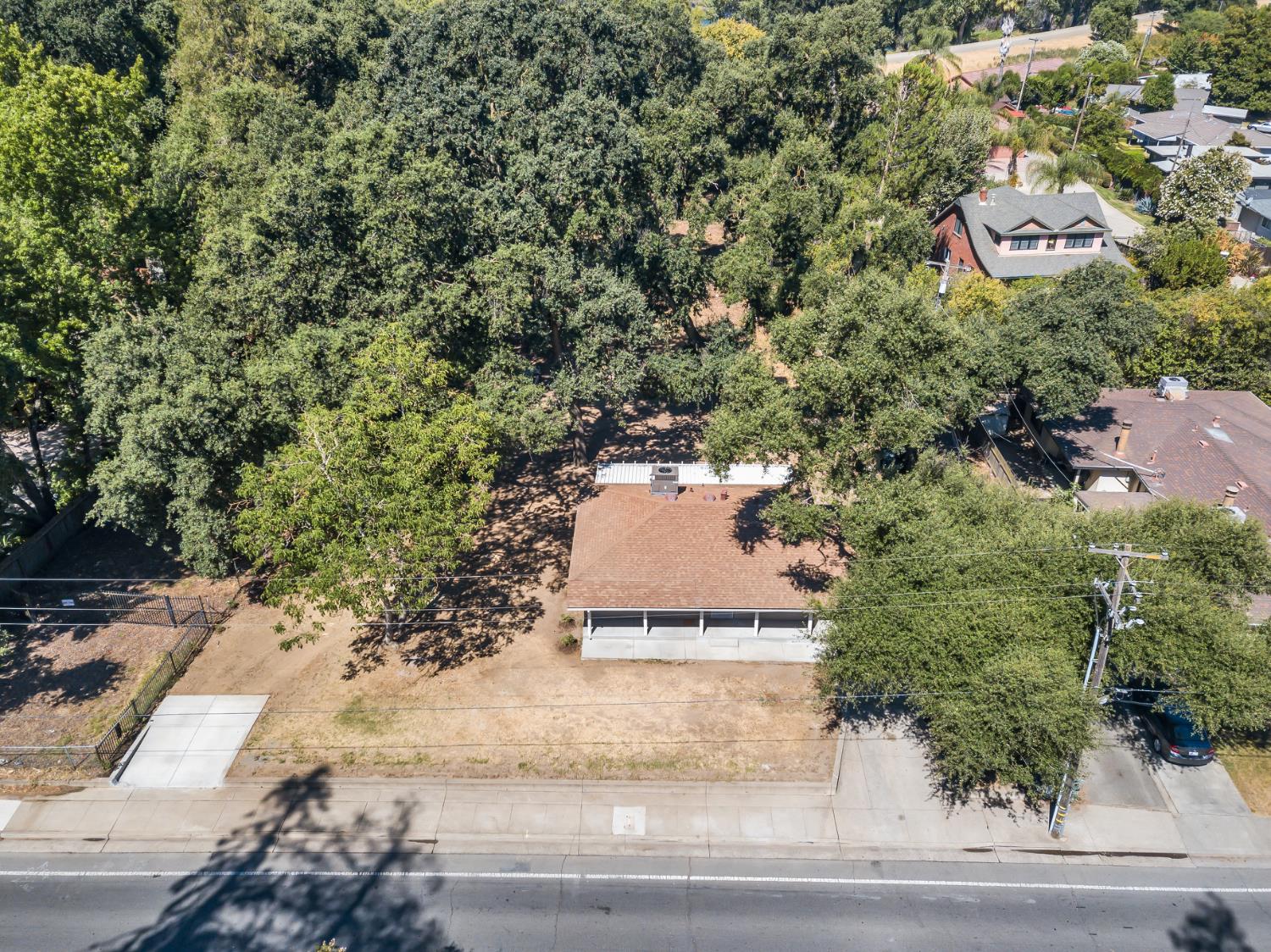 5720 Riverside Boulevard Sacramento, CA 95822 - Photo 5 of 54 an aerial view of a house with trees all around