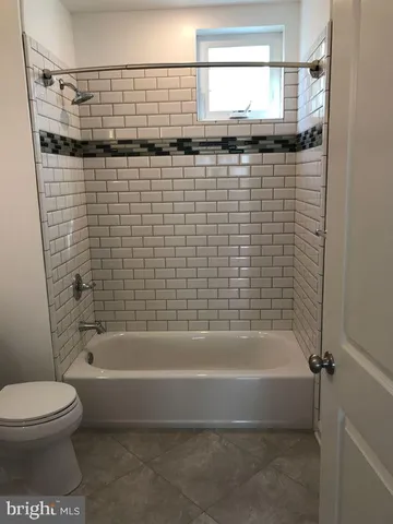 a bathroom with a shower and a toilet