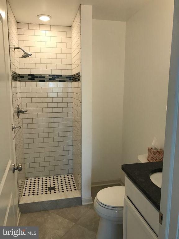 5261 Ridge Avenue, Unit 307 Philadelphia, PA 19128 - Photo 5 of 7 a bathroom with a sink toilet and shower
