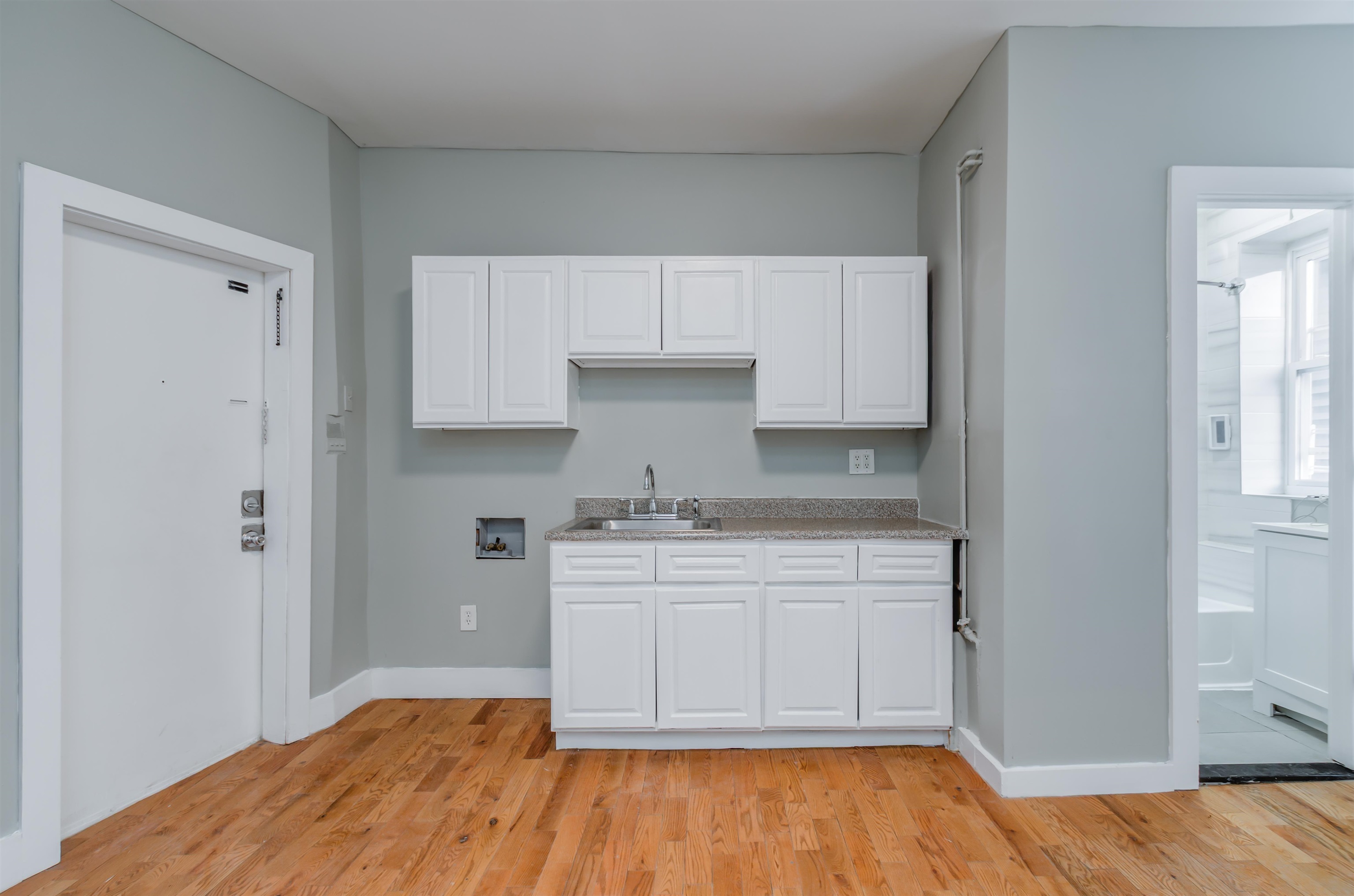 80 West 18th Street, Unit 6 Bayonne, NJ 07002 - Photo 4 of 13 a kitchen with a stove and white cabinets