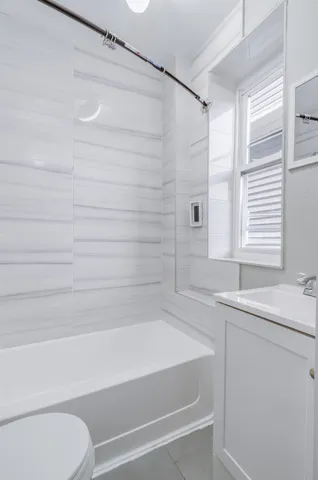 a bathroom with a bathtub and a sink