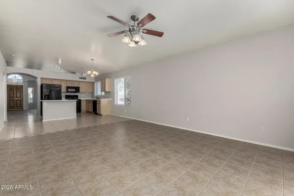 a view of a livingroom with furniture and a kitchen