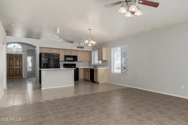 a view of a kitchen with a sink stainless steel appliances and cabinets