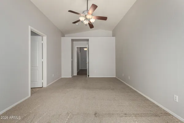 an empty room with a ceiling fan and a window