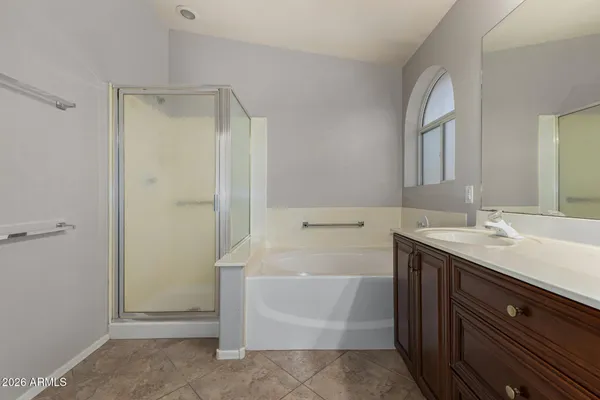 a bathroom with a tub sink and mirror