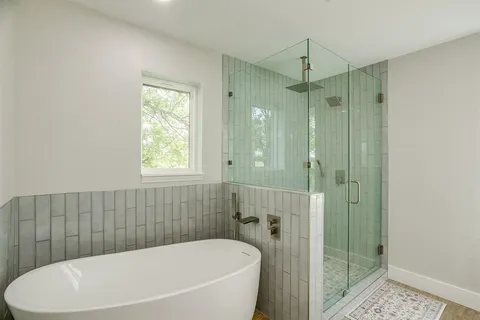 a bathroom with a bathtub and shower