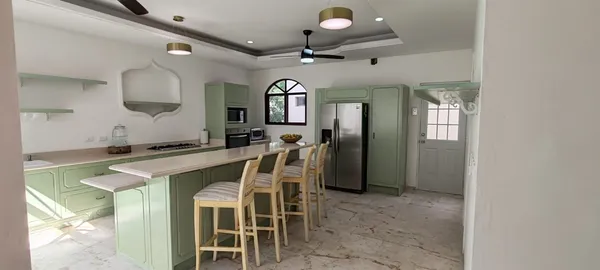 a view of a dining room with furniture and a chandelier