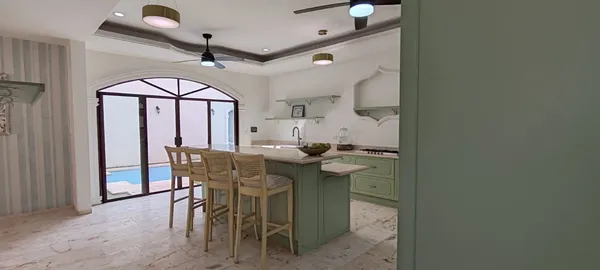 a view of a dining room with furniture and a chandelier