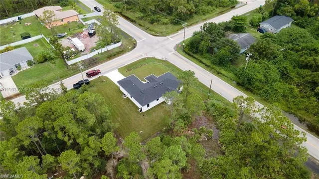 a aerial view of a house with table and chairs