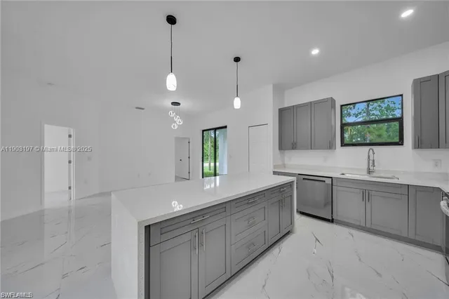 a large white kitchen with a large window