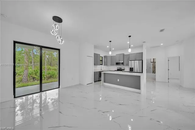 a large white kitchen with a large window