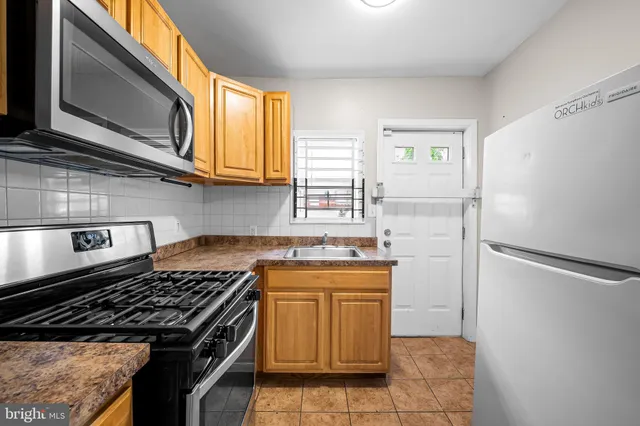 a kitchen with a stove and a refrigerator