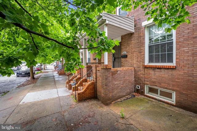 a view of a patio with table and chairs and potted plants