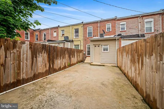 a view of a house with a wooden fence