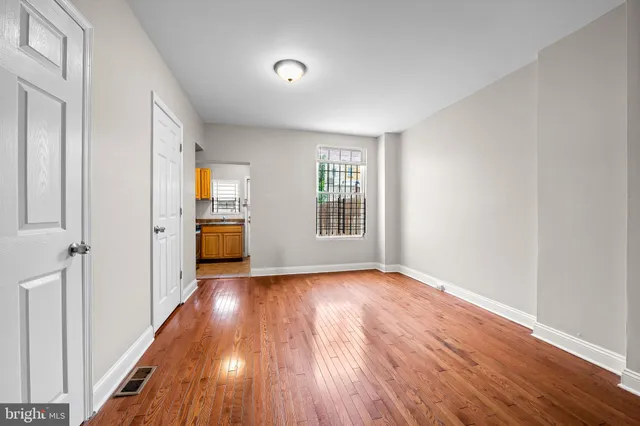 wooden floor in an empty room with a window