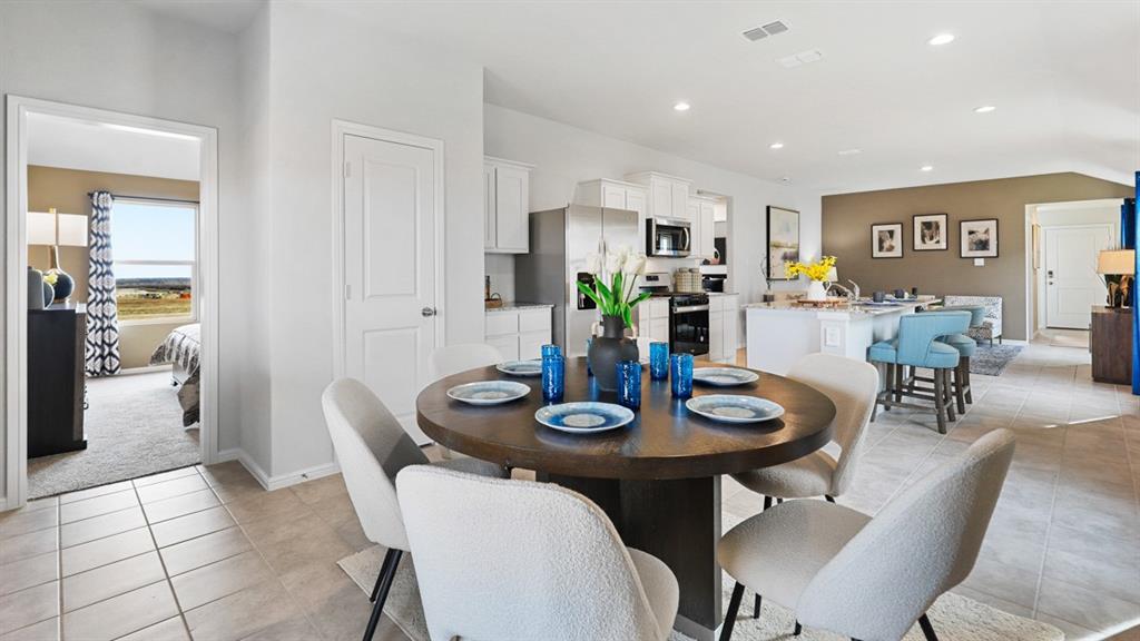 504 Marsh Street Cleburne, TX 76033 - Photo 9 of 39 a view of a dining room with furniture and wooden floor