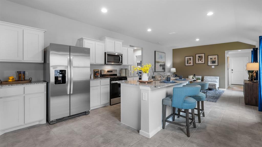 504 Marsh Street Cleburne, TX 76033 - Photo 37 of 39 a kitchen with counter space cabinets and stainless steel appliances