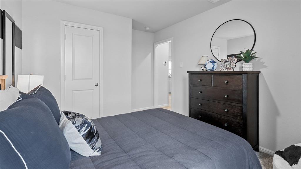 504 Marsh Street Cleburne, TX 76033 - Photo 27 of 39 a bedroom with a bed and a dresser