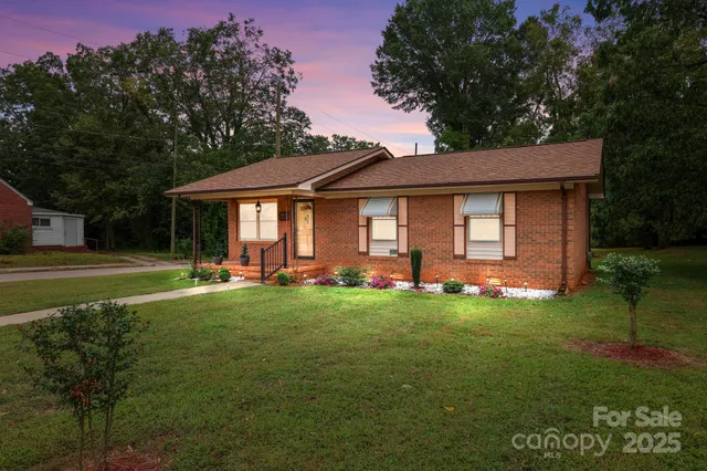 a front view of a house with a garden