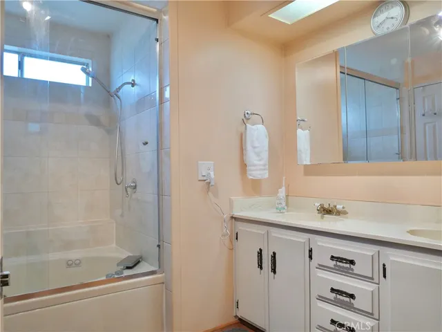 a bedroom with a bed and large windows