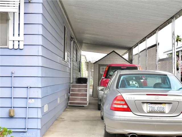 a front view of a house with a garden and chandelier