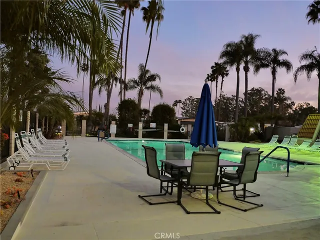 a view of a hallway with wooden floor and living room