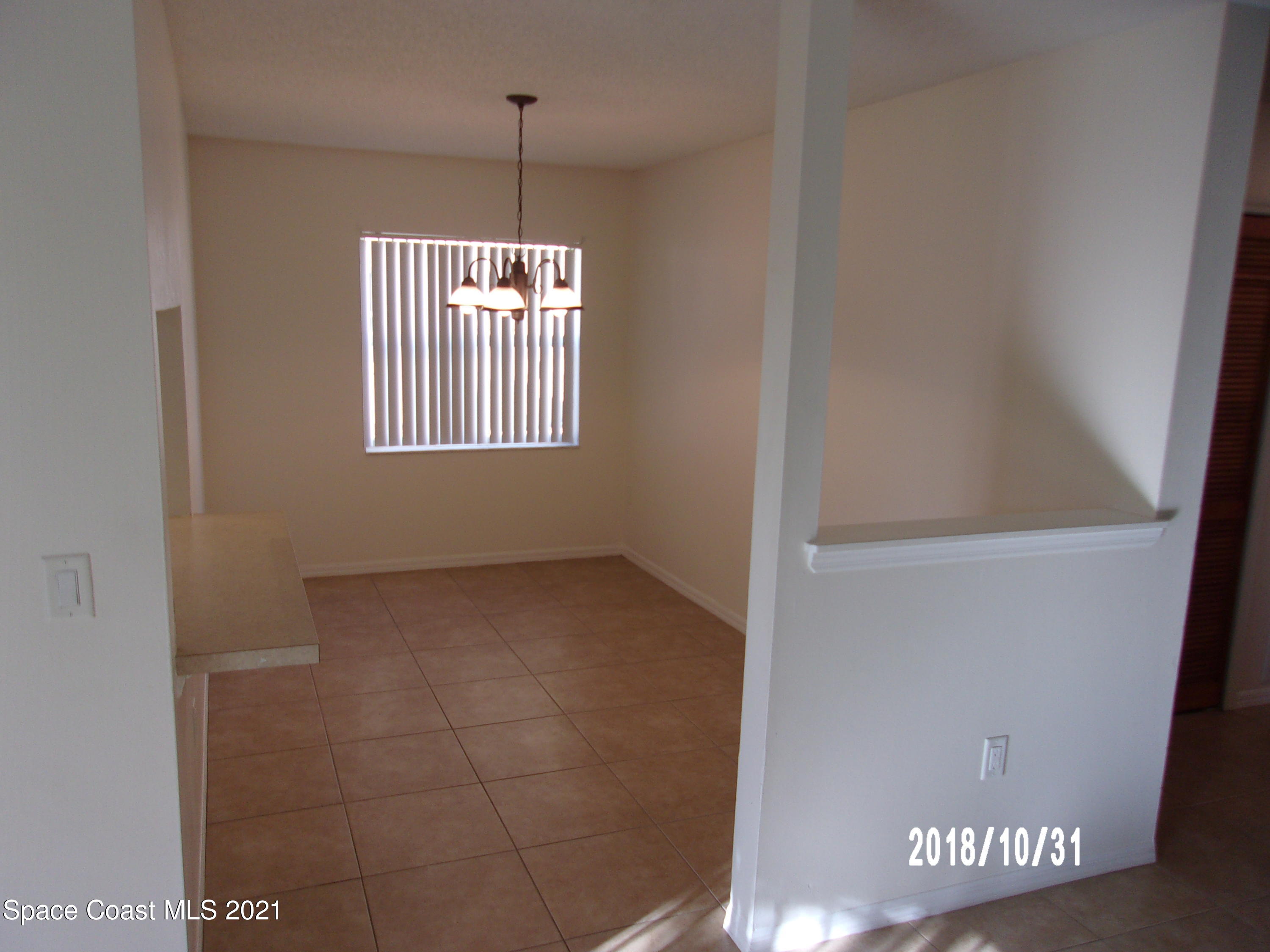 210 Spring Drive, Unit 6 Merritt Island, FL 32953 - Photo 12 of 35 a view of an empty room with a window