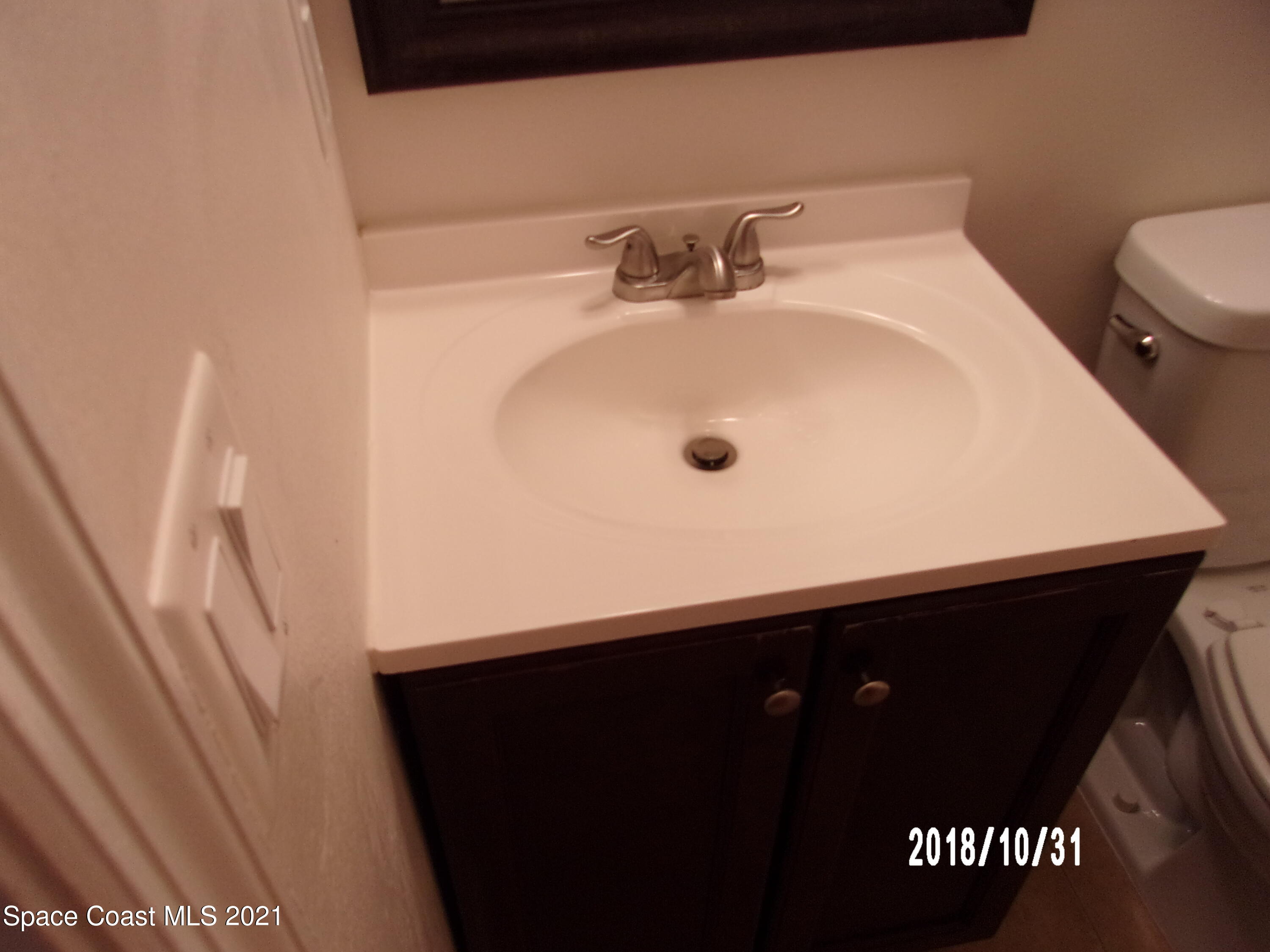 210 Spring Drive, Unit 6 Merritt Island, FL 32953 - Photo 20 of 35 a bathroom with a sink and a toilet