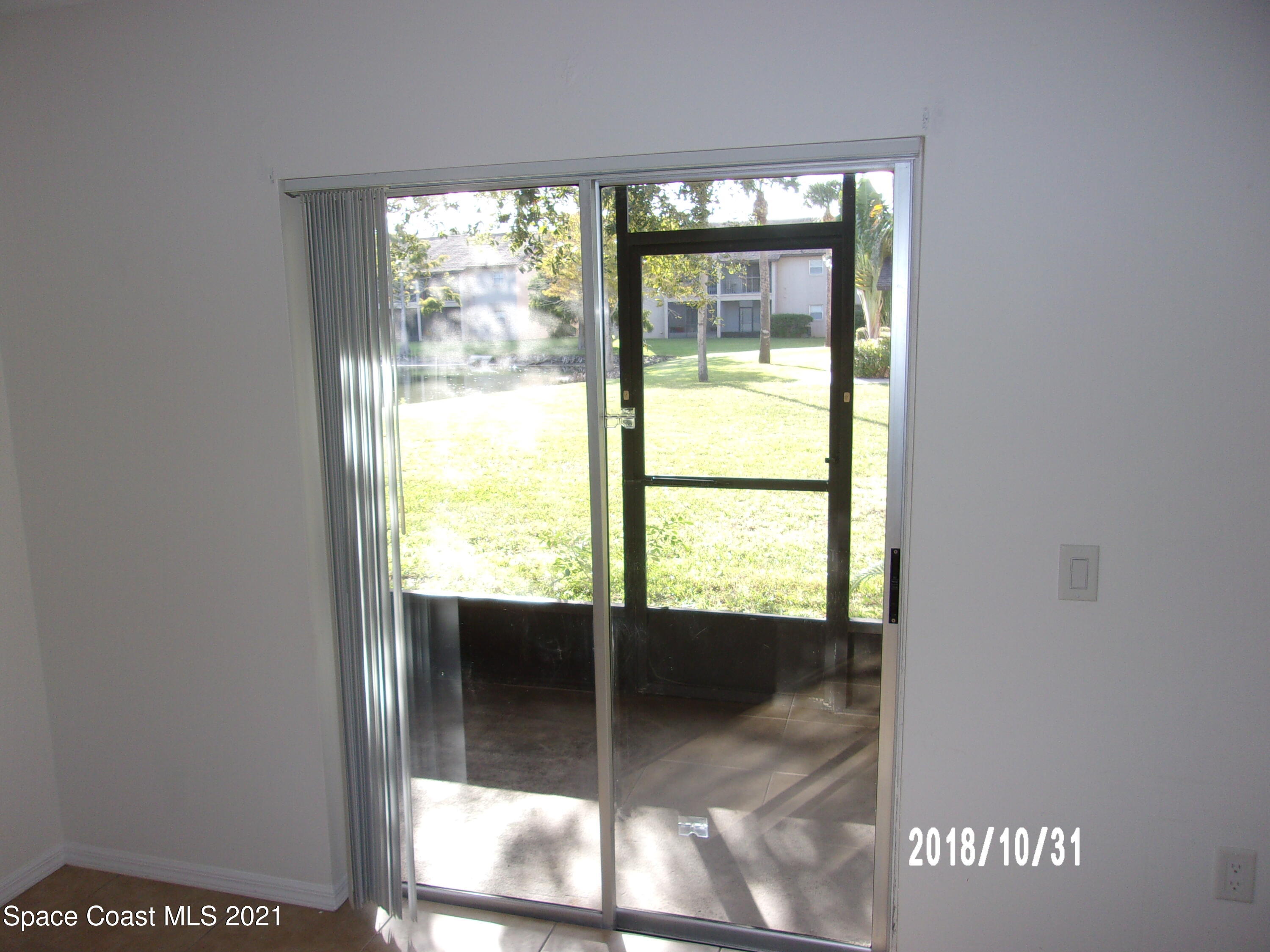 210 Spring Drive, Unit 6 Merritt Island, FL 32953 - Photo 3 of 35 a view of an empty room and window