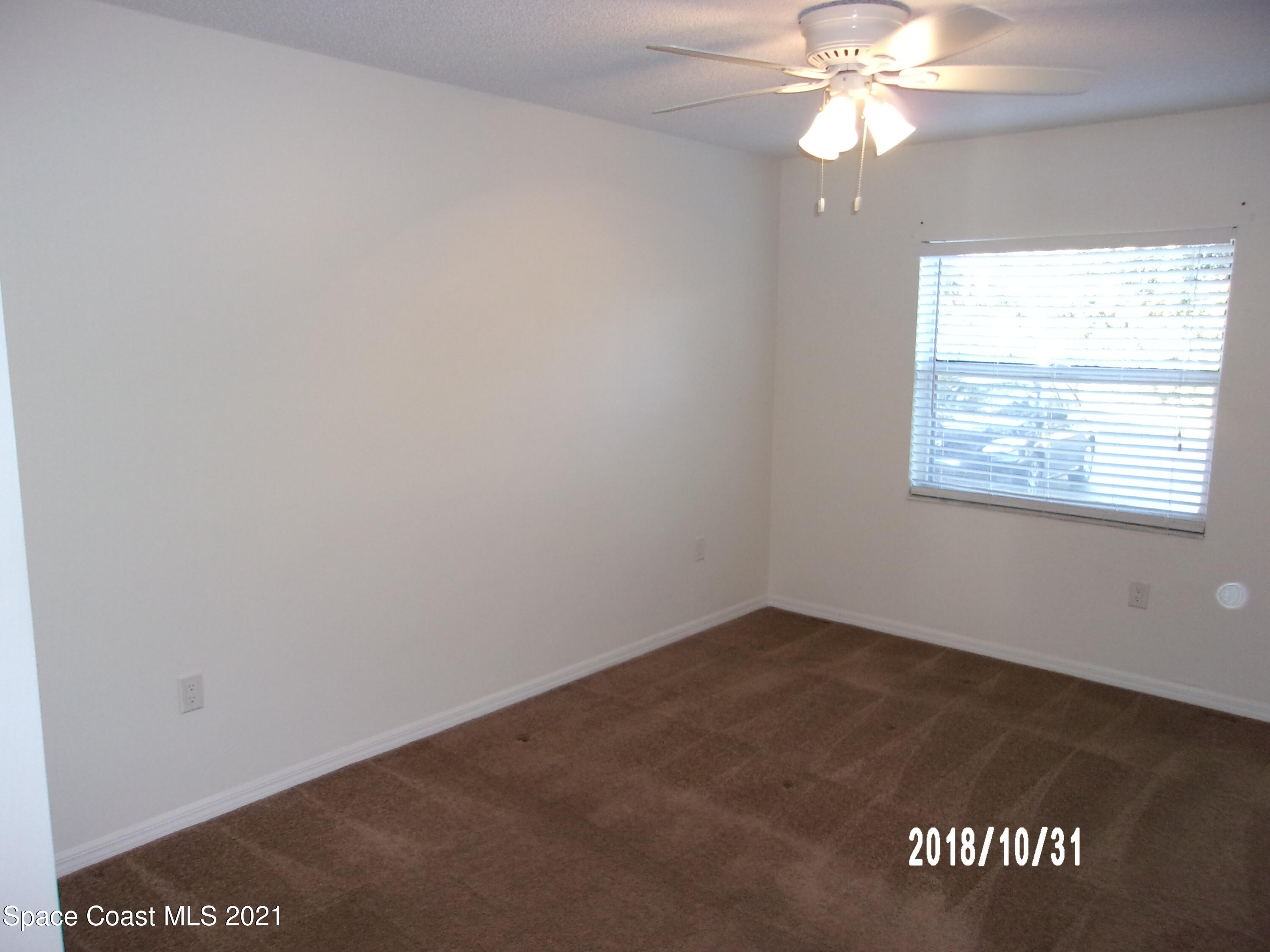 210 Spring Drive, Unit 6 Merritt Island, FL 32953 - Photo 24 of 35 an empty room with a window