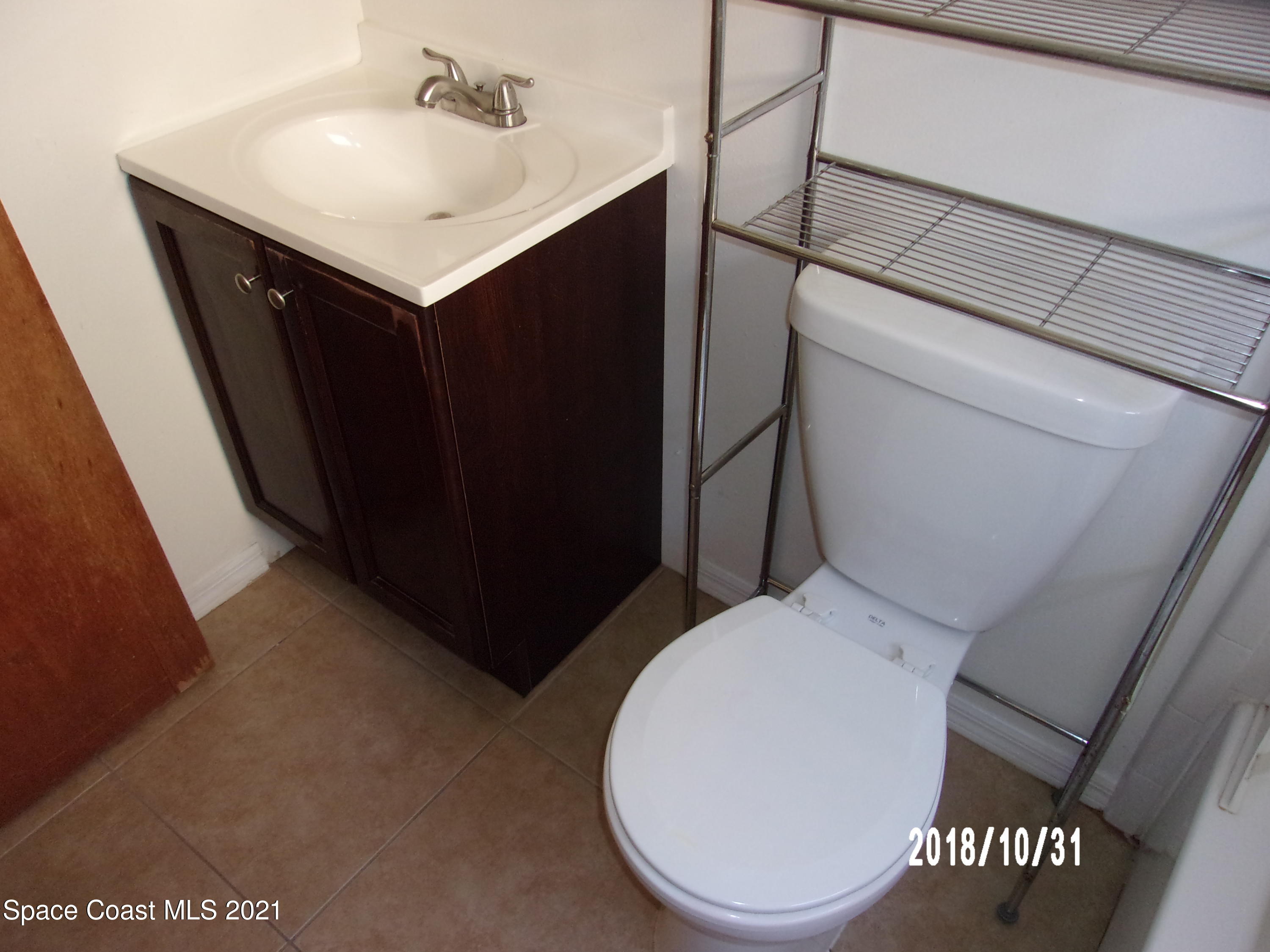 210 Spring Drive, Unit 6 Merritt Island, FL 32953 - Photo 26 of 35 a bathroom with a sink toilet and vanity