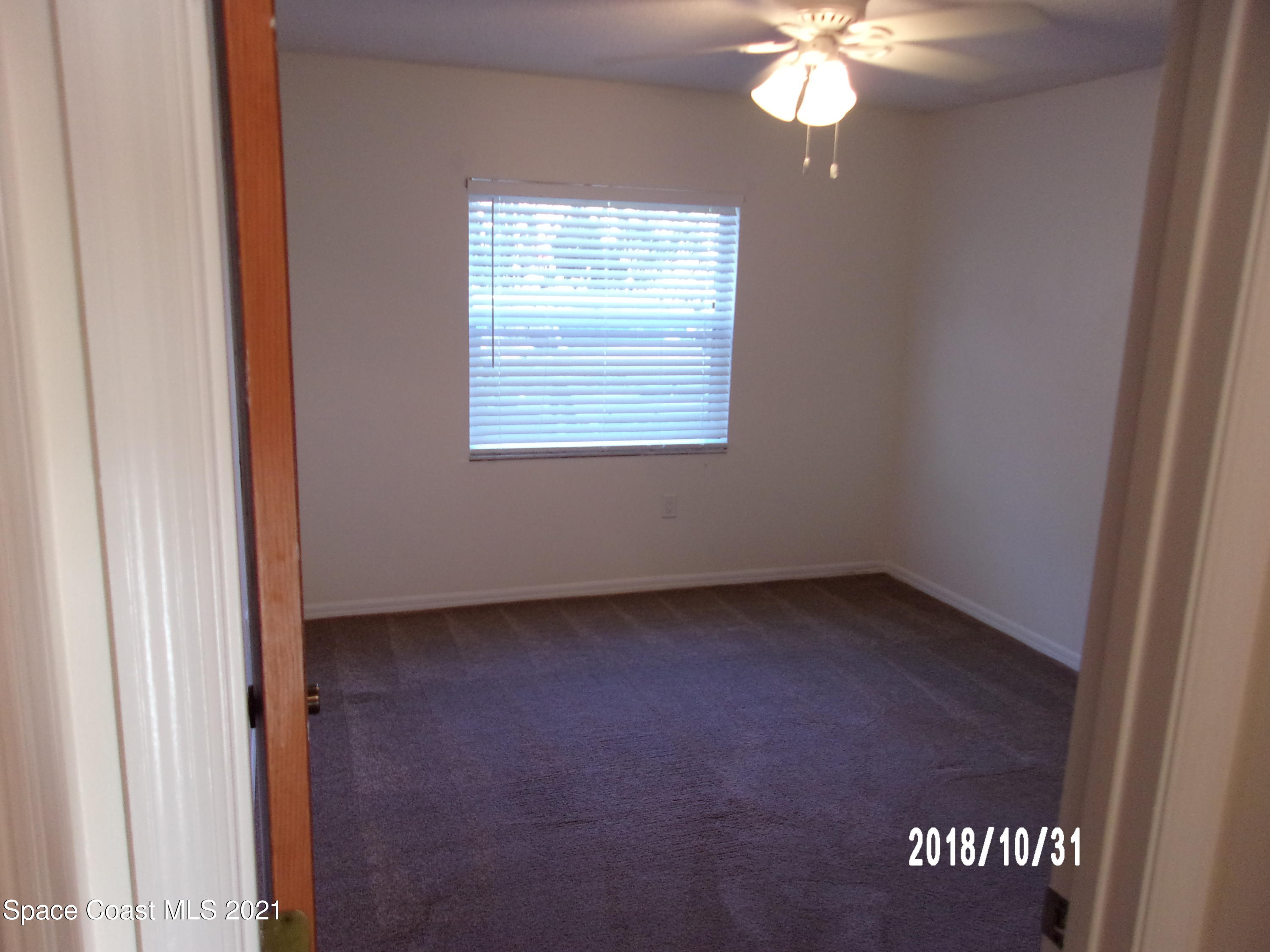210 Spring Drive, Unit 6 Merritt Island, FL 32953 - Photo 30 of 35 an empty room with a window