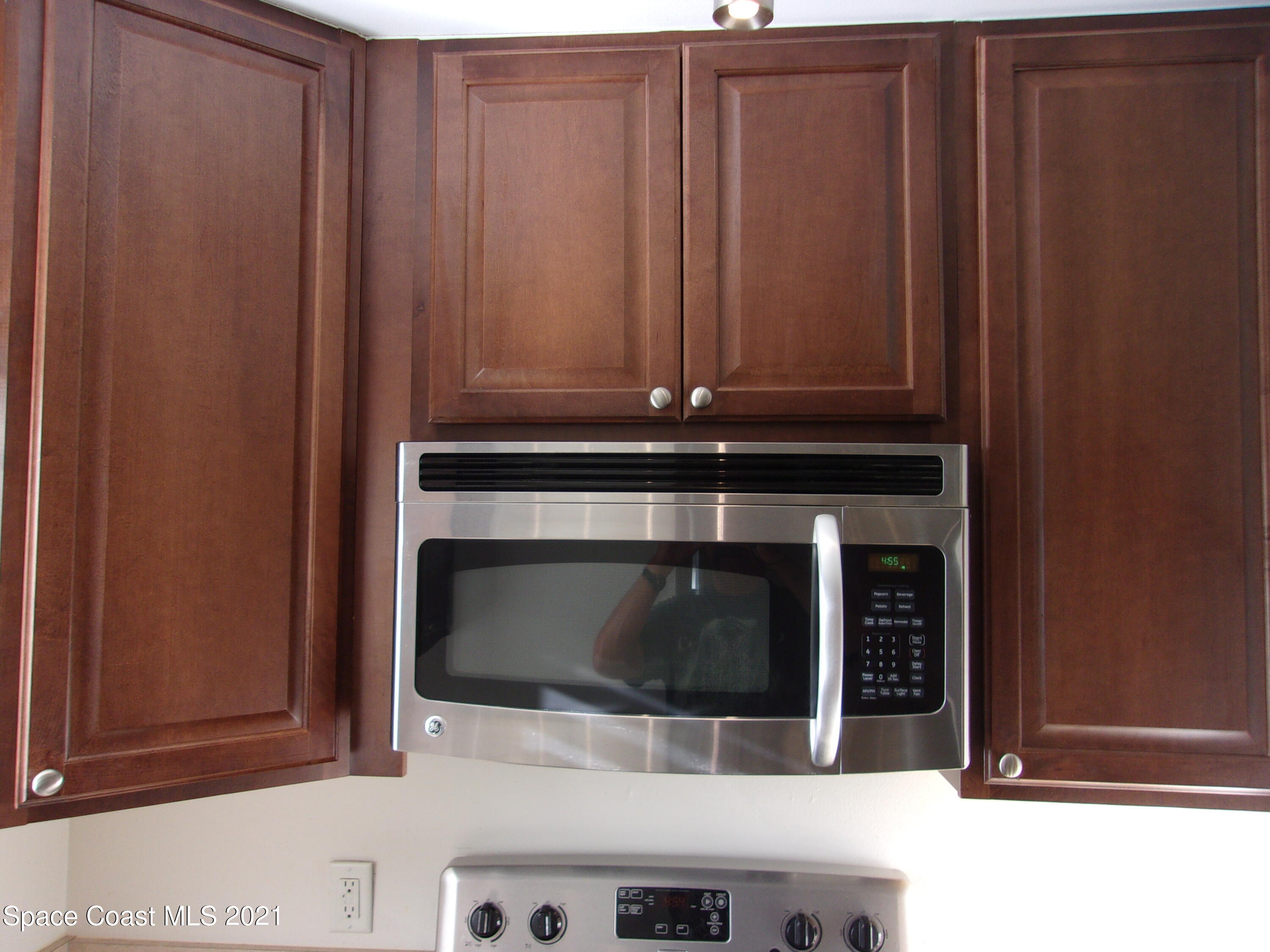 210 Spring Drive, Unit 6 Merritt Island, FL 32953 - Photo 5 of 35 a stove top oven sitting inside of a kitchen