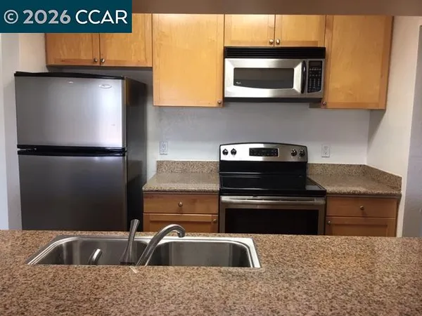 a kitchen with a sink and a microwave