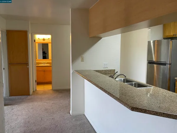 a kitchen with kitchen island a counter top space and stainless steel appliances