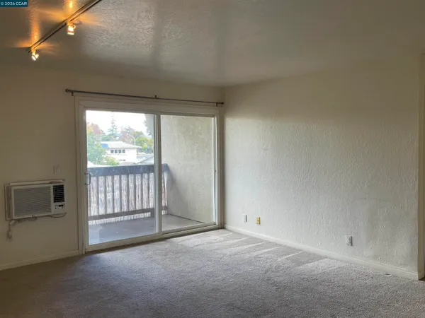a view of a livingroom with an empty space and a fireplace