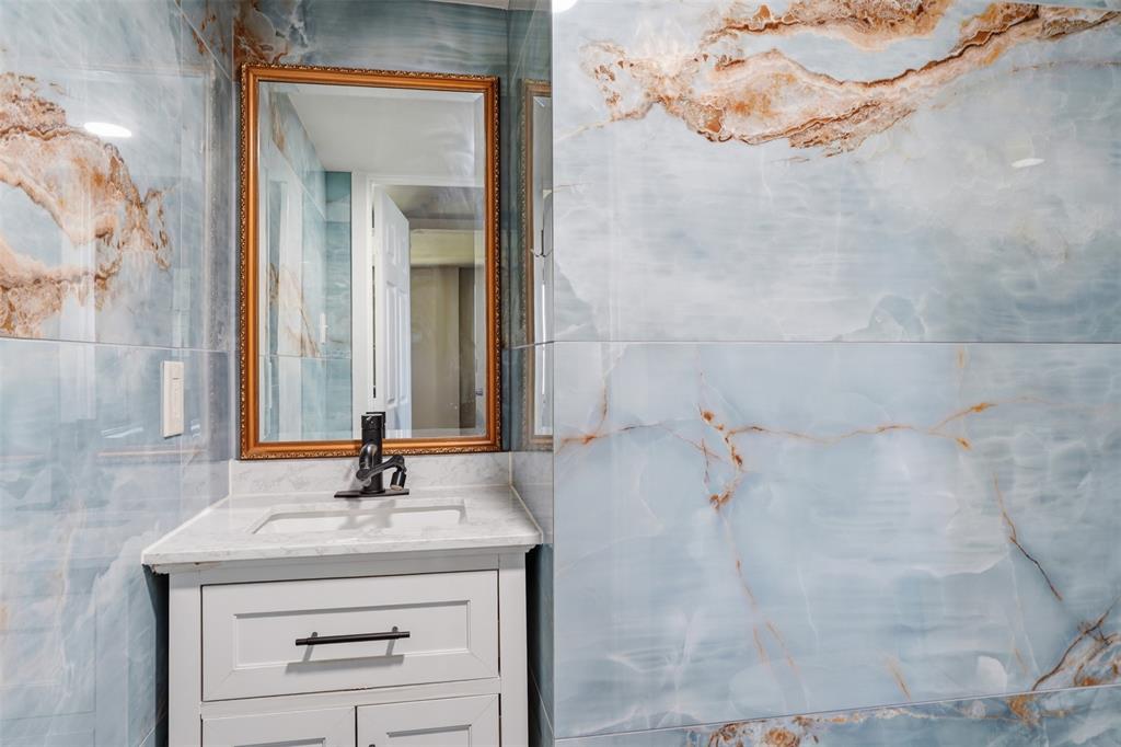 13280 Beach Club Road The Colony, TX 75056 - Photo 14 of 40 a bathroom with a sink and a mirror